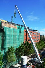 building under construction with crane