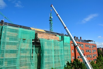 building under construction with crane