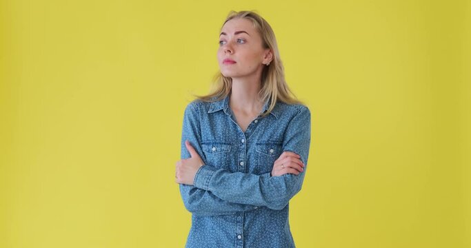 Impatient and bored woman leaving after waiting for someone over yellow background