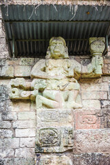 Fototapeta na wymiar It's One of two simian sculptures on Temple 11, Howler Monkey Gods. Copan, Honduras