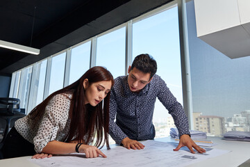 team of designers, architects and engineers, working in a cowork or meeting space, on their plans and decision making