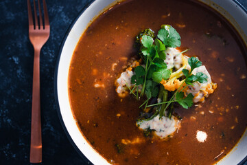 plant-based food, vegan lentil soup with caulini and broccolini and vegan cream cheese topping