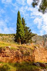 It's Delphi, an archaeological site in Greece, at the Mount Parnassus. Delphi is famous by the oracle at the sanctuary dedicated to Apollo. UNESCO World heritage