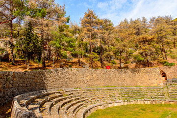 It's Amphitheater in Delphi, an archaeological site in Greece, at the Mount Parnassus. Delphi is famous by the oracle at the sanctuary dedicated to Apollo. UNESCO World heritage