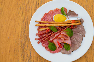 Assortment of canapes with meat. Banquet service. catering food, snacks with cheese, jamon, prosciutto and fruit. Snacks for buffet at the reception. Decorated catering banquet menu.