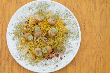 Snails for banquet service. catering food, snacks with cheese, jamon, prosciutto and fruit. Snacks for buffet at the reception. Decorated catering banquet menu with different food.
