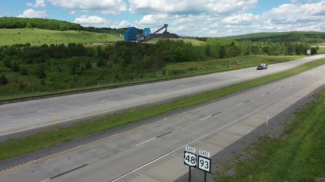 Aerial view of road signs for Corridor H, 48 and 93 West in Mount Storm, West Virginia showing vacation travel trailer.
