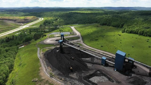 Aerial view over a coal mine with equipment elevator in Mount Storm, West Virginia showing Appalachian mountain landscape.
