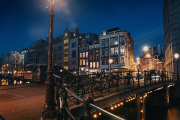 Night Amsterdam city view, Netherlands, traditional houses and river, Netherlands.