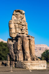 It's Colossus of Memnon, massive stone statue of Pharaoh Amenhotep III, Luxor, Egypt