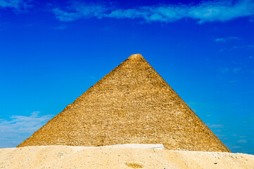 Fototapeta na wymiar It's Great Pyramid of Giza (Pyramid of Khufu or the Pyramid of Cheops), the oldest and largest of the three pyramids in the Giza Necropolis, the oldest one of the Seven Wonders of the Ancient World