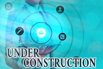 Text sign showing Under Construction. Business photo showcasing building that is unfinished but...