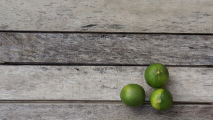 green limes on a wooden table