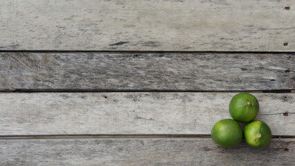 green limes on a wooden table