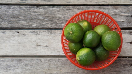 green limes on a wooden table