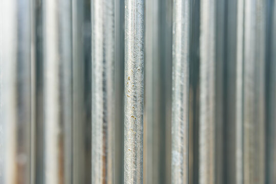Silver steel metal bar close-up, with unfocused background, industrial concept.