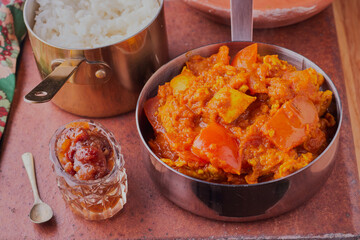 Homemade chicken curry with rice and curried apple chutney.
