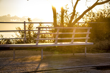 A bench of a park on Naoshima where the sun's beautiful rays shine in the evening_01