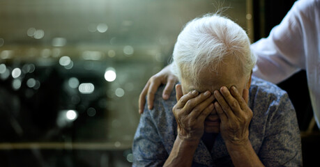 The daughter is comforting an elderly woman who is a mother sadness with Alzheimer's disease and...