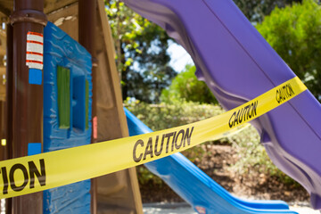 A view of caution tape wrapped around a slide, part of a playground area, during the Covid-19 pandemic, seen in Los Angeles, California.