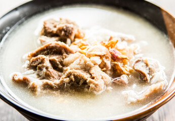 Pork bone boiled rice  in bowl, out door Chiangmai Thailand