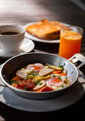 Breakfast or lunch with Fried egg, bread toast, green asparagus, tomatoes and bacon on black plate. Top view. Copy space. Banner.