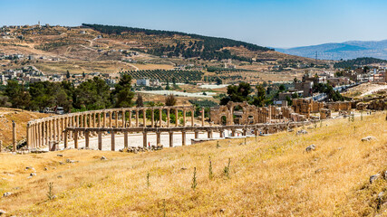 Fototapeta na wymiar It's Colonnade on the Roman Oval Forum, Ancient Roman city of Gerasa of Antiquity , modern Jerash, Jordan