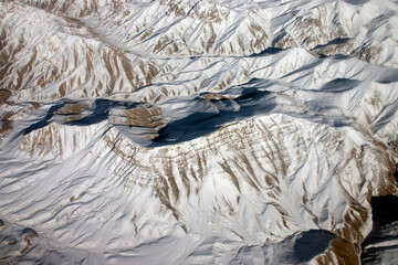 Aerial photograph of the snow covered Hindu Kush mountain range on a cold and crispy winters morning