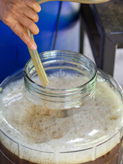 Close-up of woman hand holding a rubber strap to let the craft beer flow out