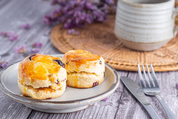 Traditional British scones with a tea cup and blurred background
