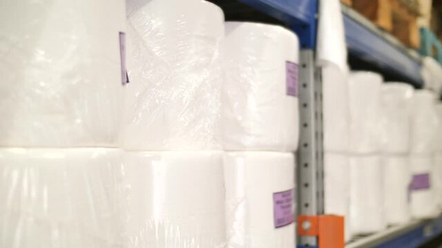 Packages of paper towels on shelf, warehouse supply close up