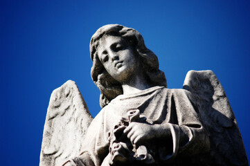 Close View of an Angel Statue Against Blue sky