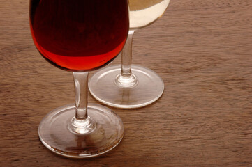 Wine Glasses containing red and white wine on wooden table