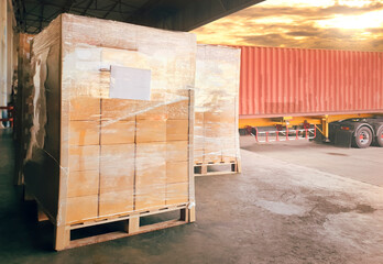 Stacked of Package Boxes Load with Cargo Container. Trailer Truck Parked Loading at Dock Warehouse. Delivery Service. Shipping Warehouse Logistics. Cargo Shipment. Freight Truck Transportation.