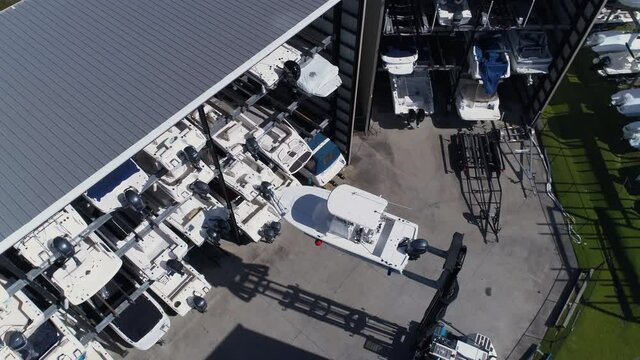 Aerial Shot Circles Forklift Placing Boat on Marina Storing Rack