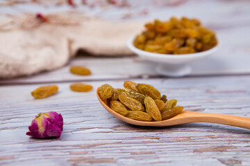 Raisins in a wooden spoon