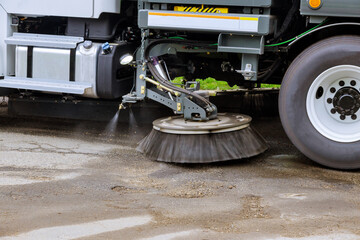 Street sweeper machine cleaning the streets in utility service of the town.