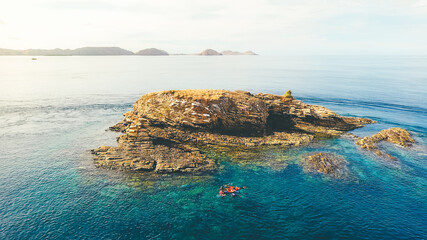 Batu Bolong Island in Komodo National Park, Indonesia. Aerial view of stone island in the midle of sea