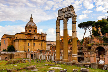 It's Roman Forum in the evening, a rectangular forum surrounded by the ruins of several important ancient government buildings at the center of the city of Rome.