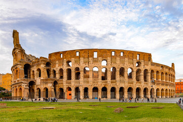 Fototapeta na wymiar It's Panoramic view of Colosseum or Coliseum in the evening, Rome, Italy. One of the main touristic destinations in Rome