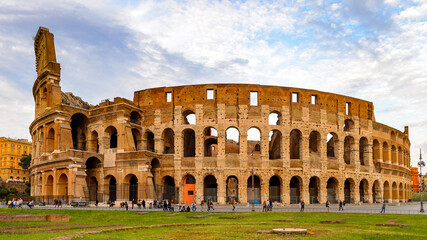 Fototapeta na wymiar It's Panoramic view of Colosseum or Coliseum in the evening, Rome, Italy. One of the main touristic destinations in Rome