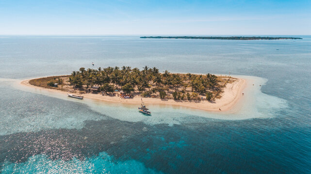Aerial view of Bedil Island, the small island with palm tree and white sands in Sumbawa, Indonesia