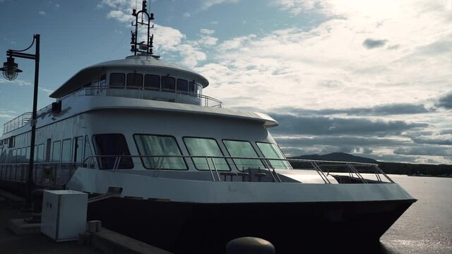 Boat Anchored On The Wharf In Lake Memphremagog In Macpherson, Magog, Quebec, Canada. - wide shot
