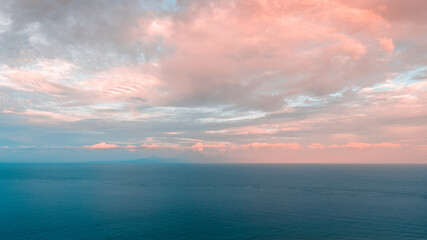 Relaxing seascape with wide horizon of blue sea and clouds sunset on sky