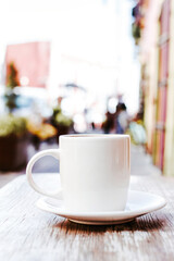 cup of coffee in the street or outdoors at coffee shop or cafe with blurred background