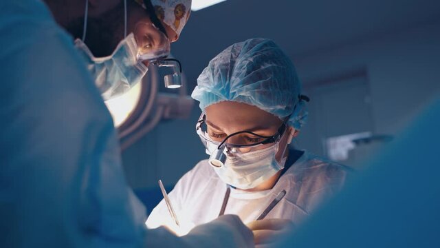 Doctor during surgery in operating room. Professional doctor performing operation in surgery room