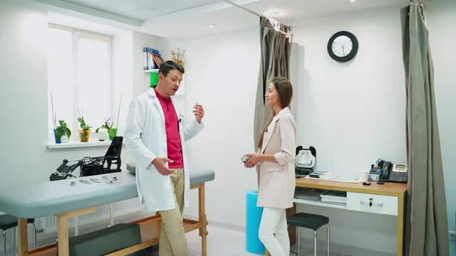 Friendly doctor and patient at hospital. Doctor and patient discussing something at hospital