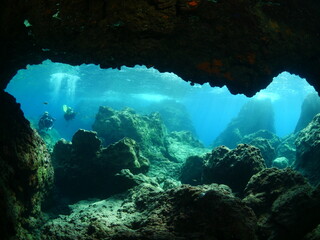 scuba divers underwater enjoying the rocks topography clean water scenery exploring the reef ocean scenery © underocean
