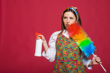 Hygiene concept. Happy girl hold colorful duster brush and rag. Cleaning service. Girl cleaner with feather duster, rag. Housewife with cleaning sweep.Woman from cleaning service with synthetic duster