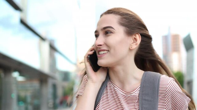 Attractive young woman using smartphone outdoors
